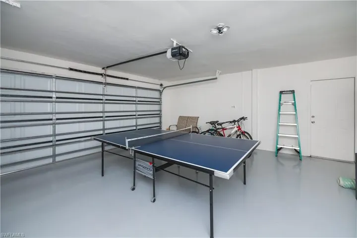 Playroom featuring a garage and finished concrete floors