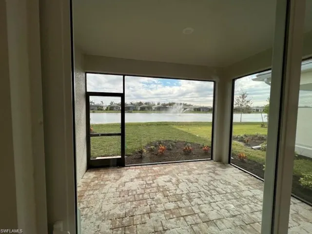 Unfurnished sunroom with a water view