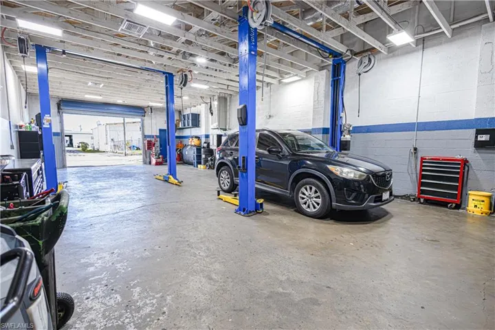 Spacious industrial interior with concrete flooring and exposed ceiling beams