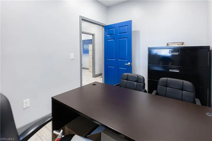 Light gray walls with a vibrant blue paneled door