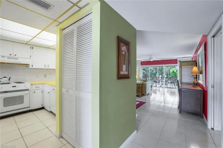 Hallway from the front door flows seamlessly into the bright kitchen and living room