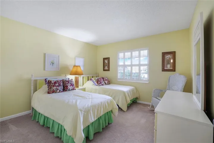 The large guest bedroom includes a large walk-in closet and cheerful natural light