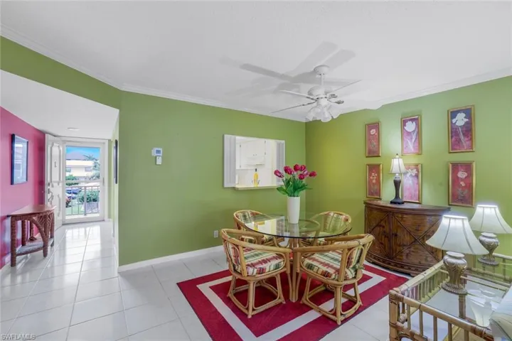Tiled dining area with ceiling fan and crown molding features room to expand your dining furniture options