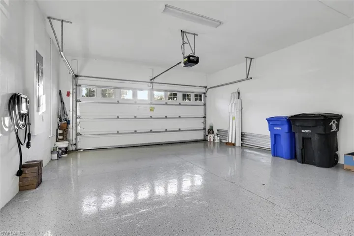 Garage featuring car charger and a garage door opener