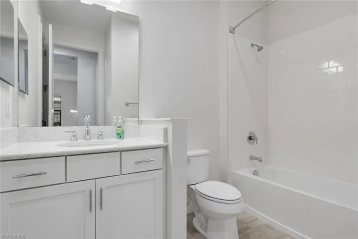 Full bath featuring vanity and shower / tub combination
