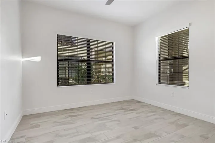 Spare room featuring a ceiling fan and light wood-style flooring