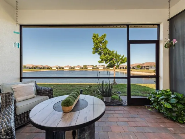 Sunroom / solarium with a water view and a residential view