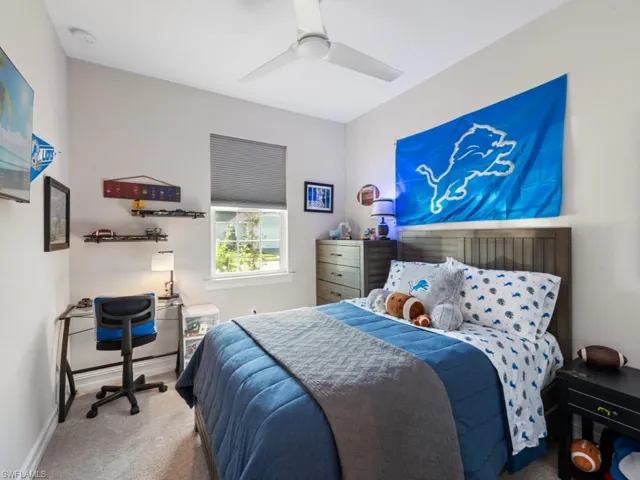 Bedroom with carpet flooring, ceiling fan, and baseboards