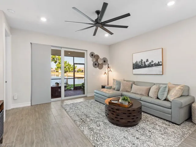 Living area with recessed lighting, light wood-style flooring, baseboards, and a ceiling fan