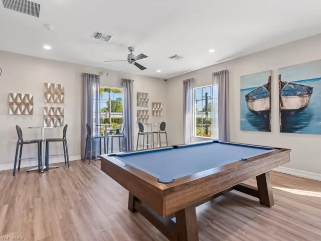 Playroom with light wood-style flooring, baseboards, billiards, and visible vents