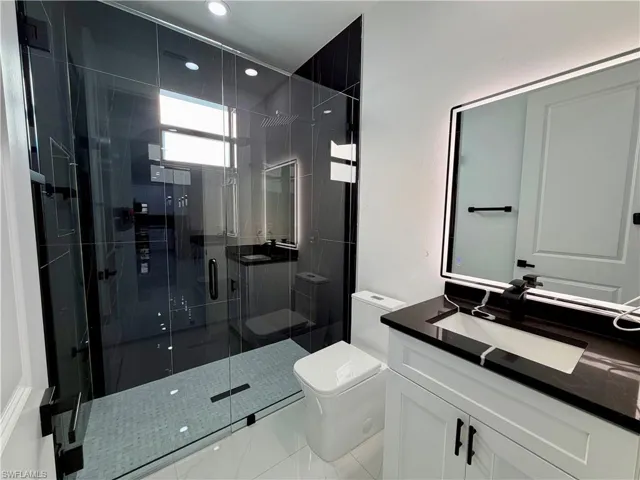 Bathroom with vanity and a shower stall