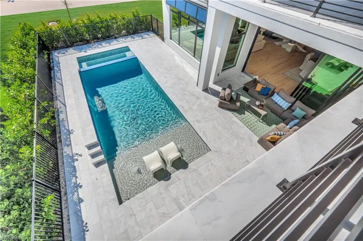 Integrated pool / spa with a patio and an outdoor living space