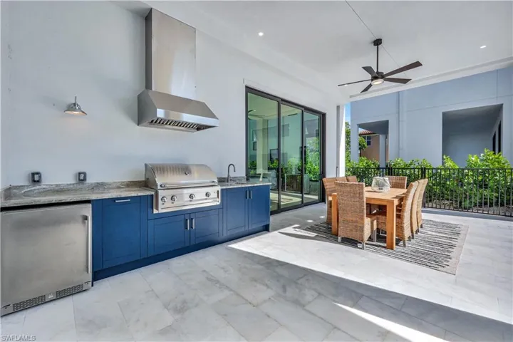 View of patio / terrace featuring an outdoor kitchen / dining area and ceiling fan