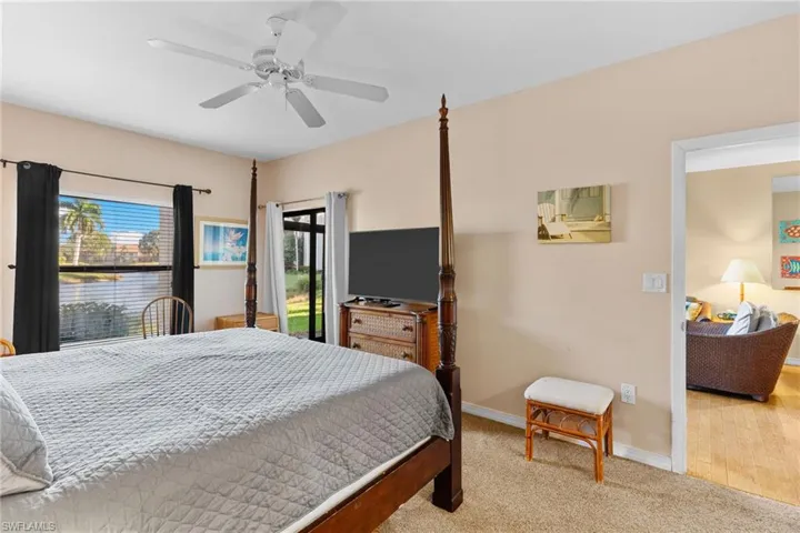 Generous primary suite offers direct access to the lanai, an en-suite bathroom, and ample closet space. The spacious screened-in lanai is the perfect retreat to relax and enjoy the peaceful waterfront scenery!