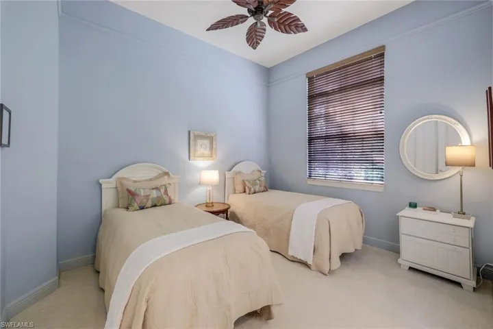 Bedroom with light carpet and ceiling fan