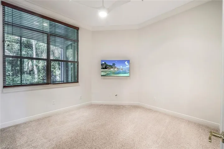 Empty room featuring carpet and crown molding