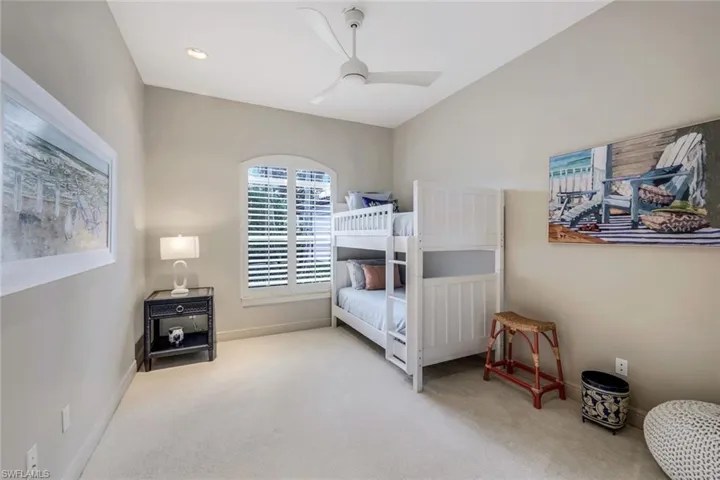 Carpeted bedroom with ceiling fan