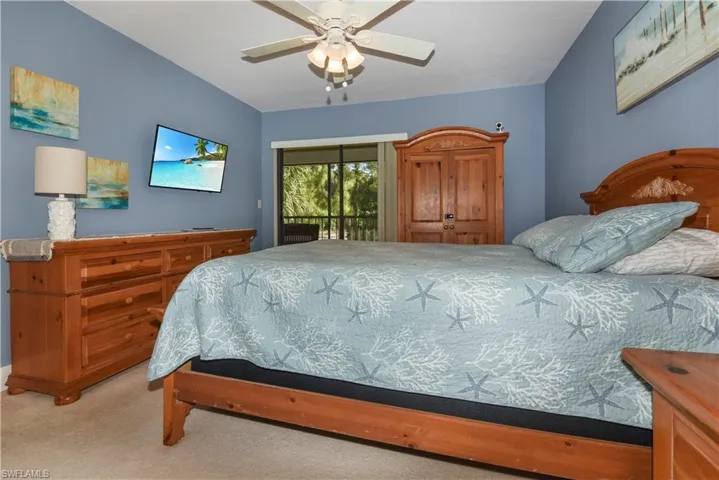Bedroom with access to outside, a ceiling fan, and light colored carpet