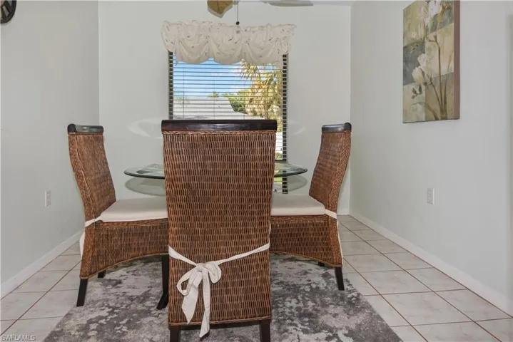 Dining area featuring light tile patterned floors and ceiling fan