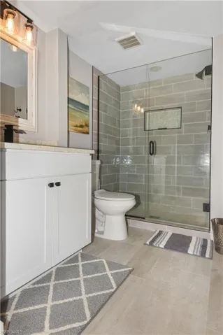 Full bathroom featuring vanity and a shower stall