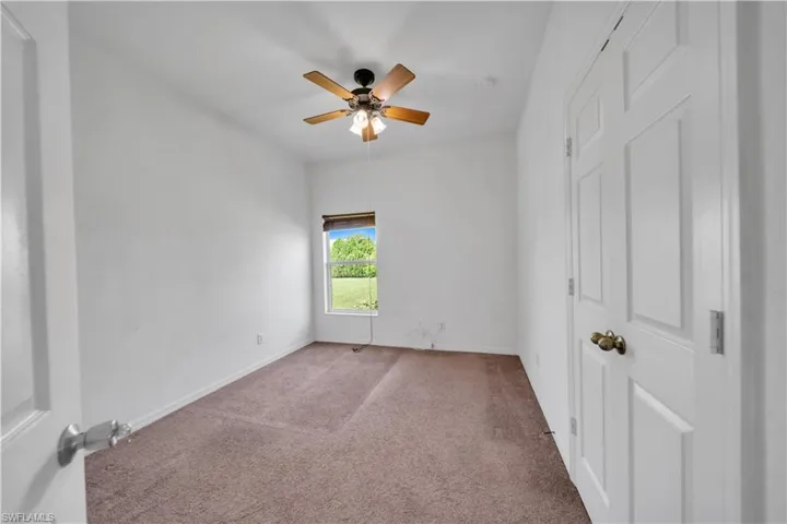 Unfurnished bedroom with carpet floors and ceiling fan