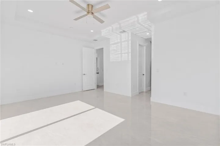 Empty room featuring a ceiling fan and recessed lighting