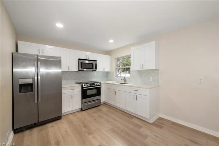 Newly installed cabinets, quartz countertops and new hardware.
