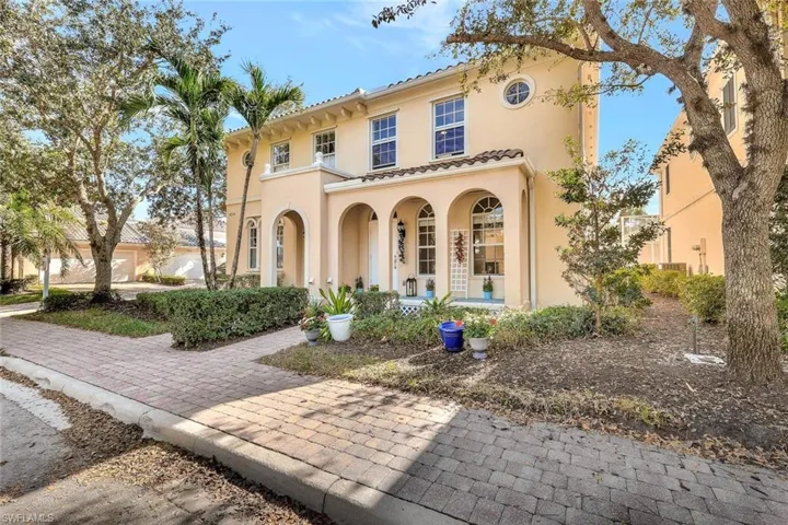 Mediterranean / spanish house with a porch, stucco siding, and a tile roof
