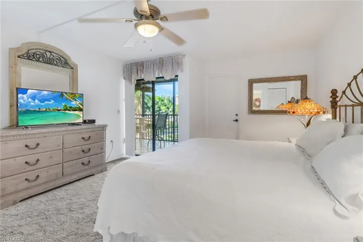 Bedroom with ceiling fan and access to outside