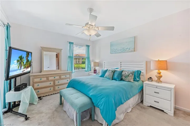 Bedroom featuring ceiling fan and light colored carpet