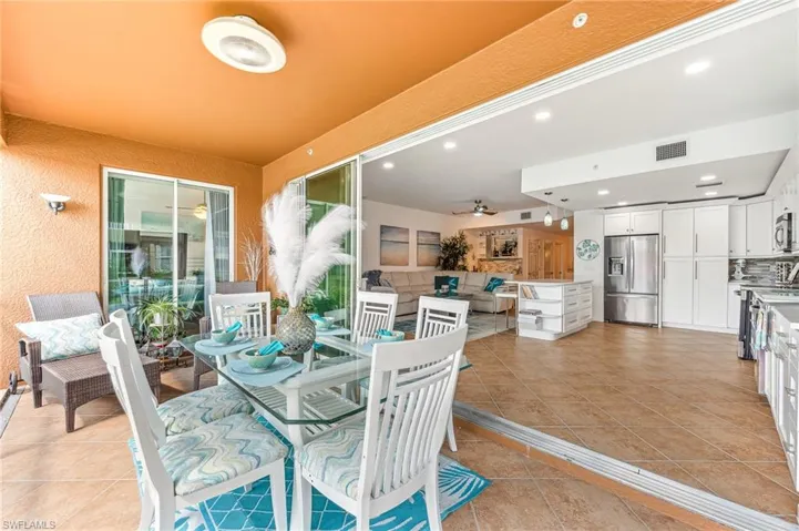 View of patio featuring ceiling fan and an outdoor living space