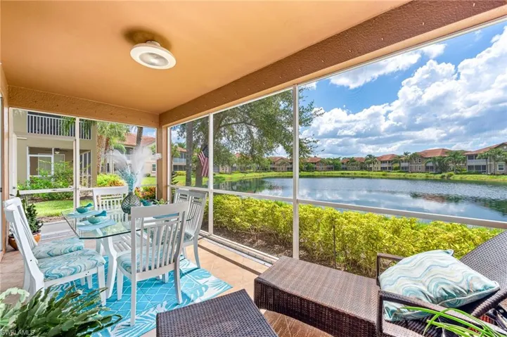 Sunroom / solarium featuring a water view