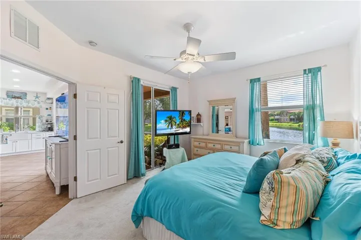 Bedroom with access to outside, ceiling fan, and light tile patterned floors