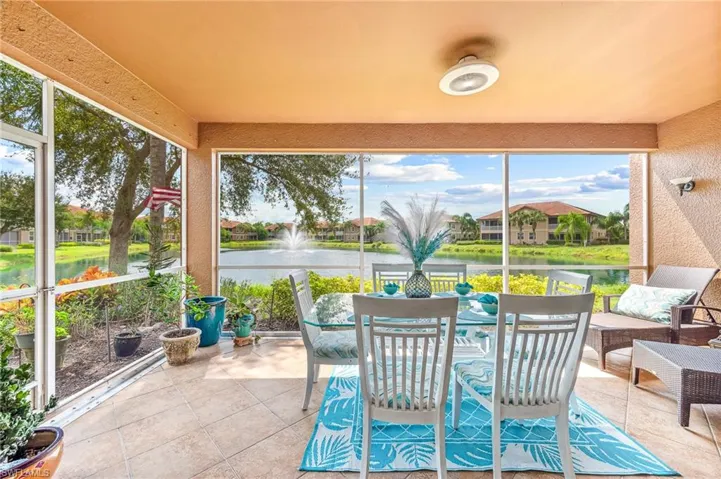 Sunroom / solarium featuring a water view