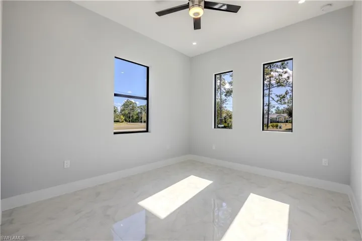Spare room with light marble finish flooring, recessed lighting, and ceiling fan