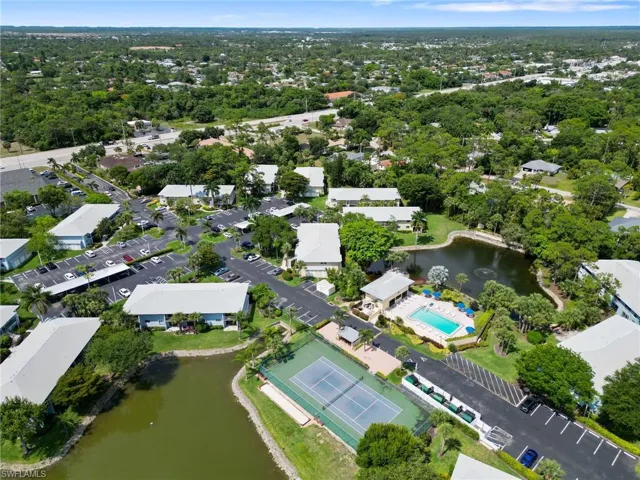 Birds eye view of property featuring a water view and pool