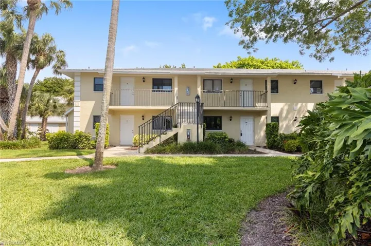 view of condo with a yard