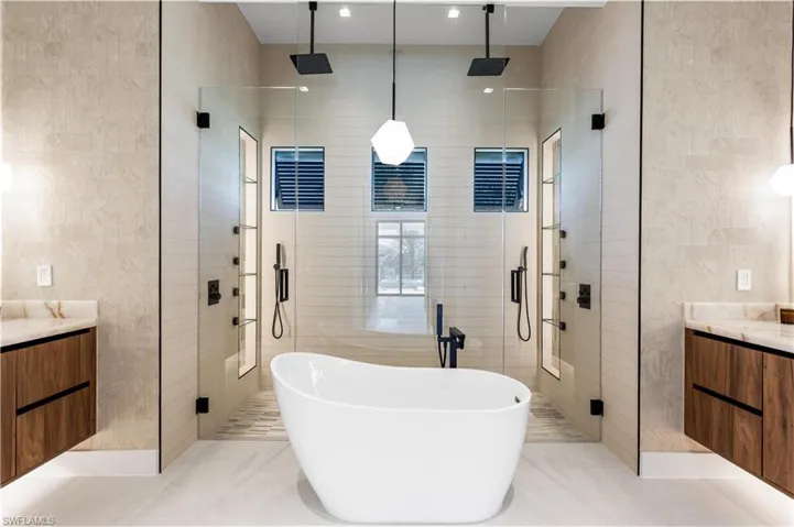 FULL GLASS WALL & DOUBLE RAINFALL SHOWERS w/ 4 jets & handheld showerheads