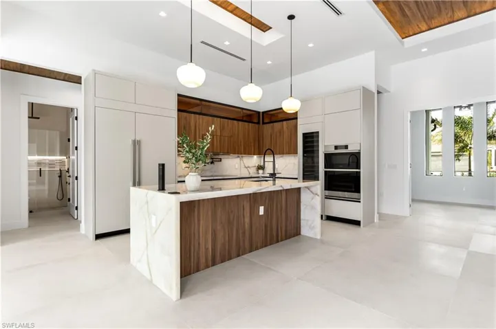 GOURMET kitchen featuring high-end appliances, ample counter space, and stylish finishes, making it a CHEF'S DREAM for PREPARING & ENTERTAINING IN STYLE!