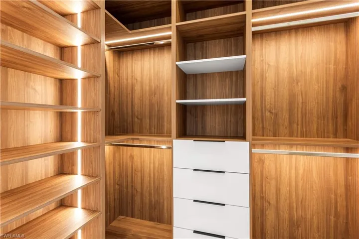 Custom made HIS AND HER CLOSET with LED shelving lights