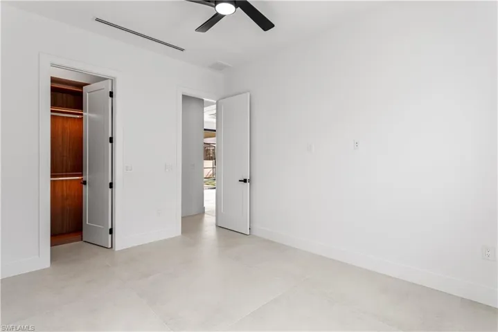 3rd guest bedroom offers ample space and closet storage, featuring custom lighted shelving cabinetry