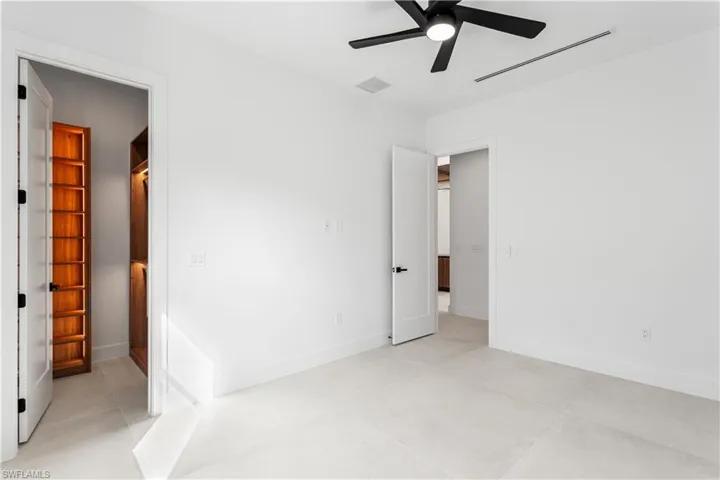 4th Guest Bedroom provides generous space and closet storage, complete with custom lighted shelving cabinetry