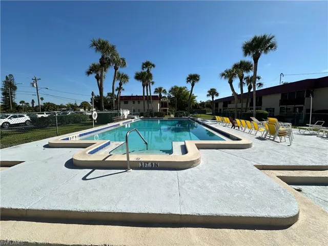 Pool featuring a patio and fence