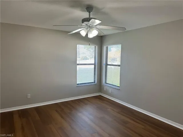 Master bedroom featuring ceiling fan and dark hardwood / wood-style floors