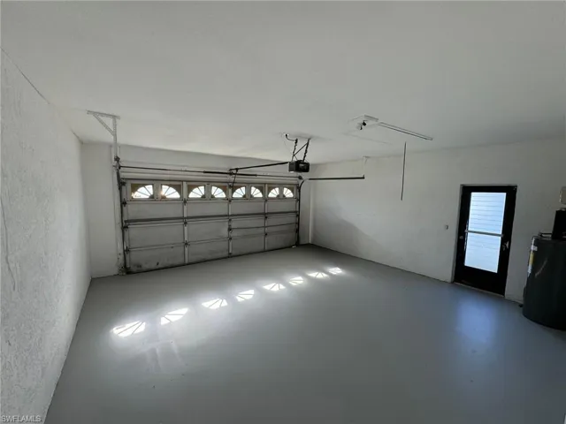 Garage featuring a garage door opener