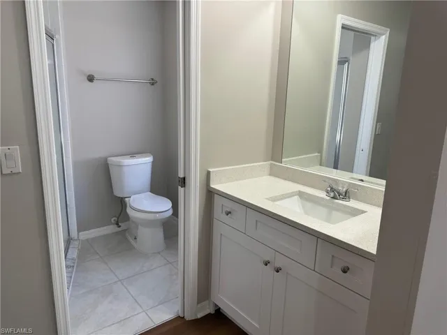 Master Bathroom featuring tile patterned flooring, toilet, and vanity