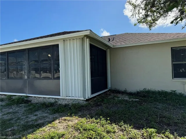 View of property exterior with a sunroom