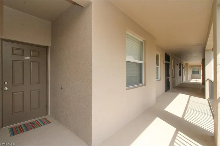 Entrance to property with stucco siding