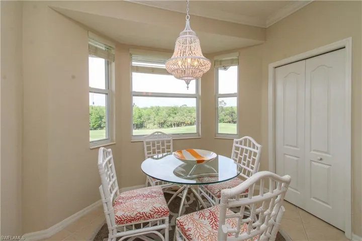 Dining area with an inviting chandelier, light tile patterned floors, plenty of natural light, and baseboards