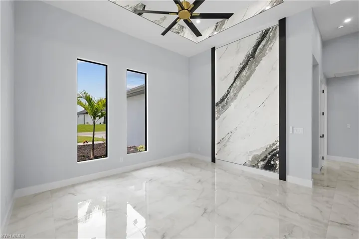 Unfurnished room with light tile patterned floors and ceiling fan